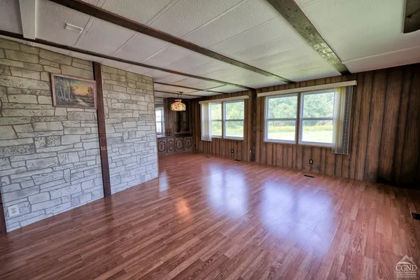 a view of hallway with wooden floor and stairs