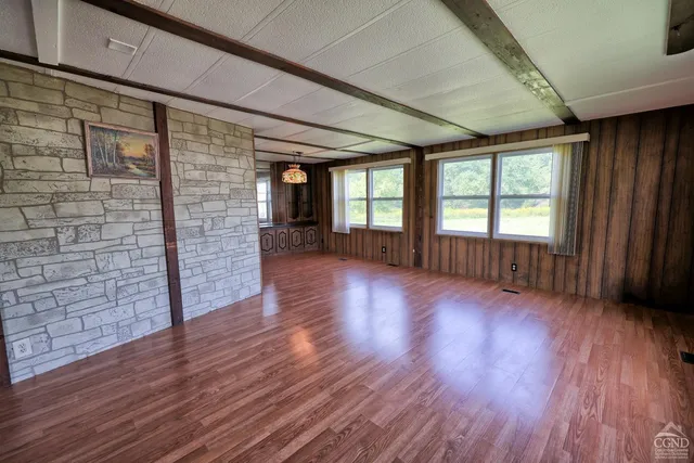 a view of hallway with wooden floor and stairs