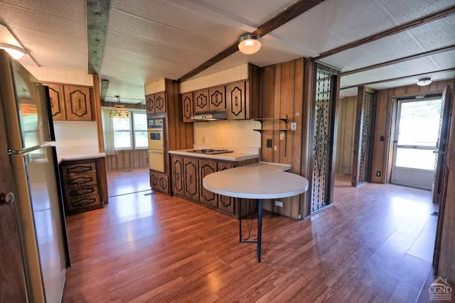 a view of kitchen with refrigerator and window