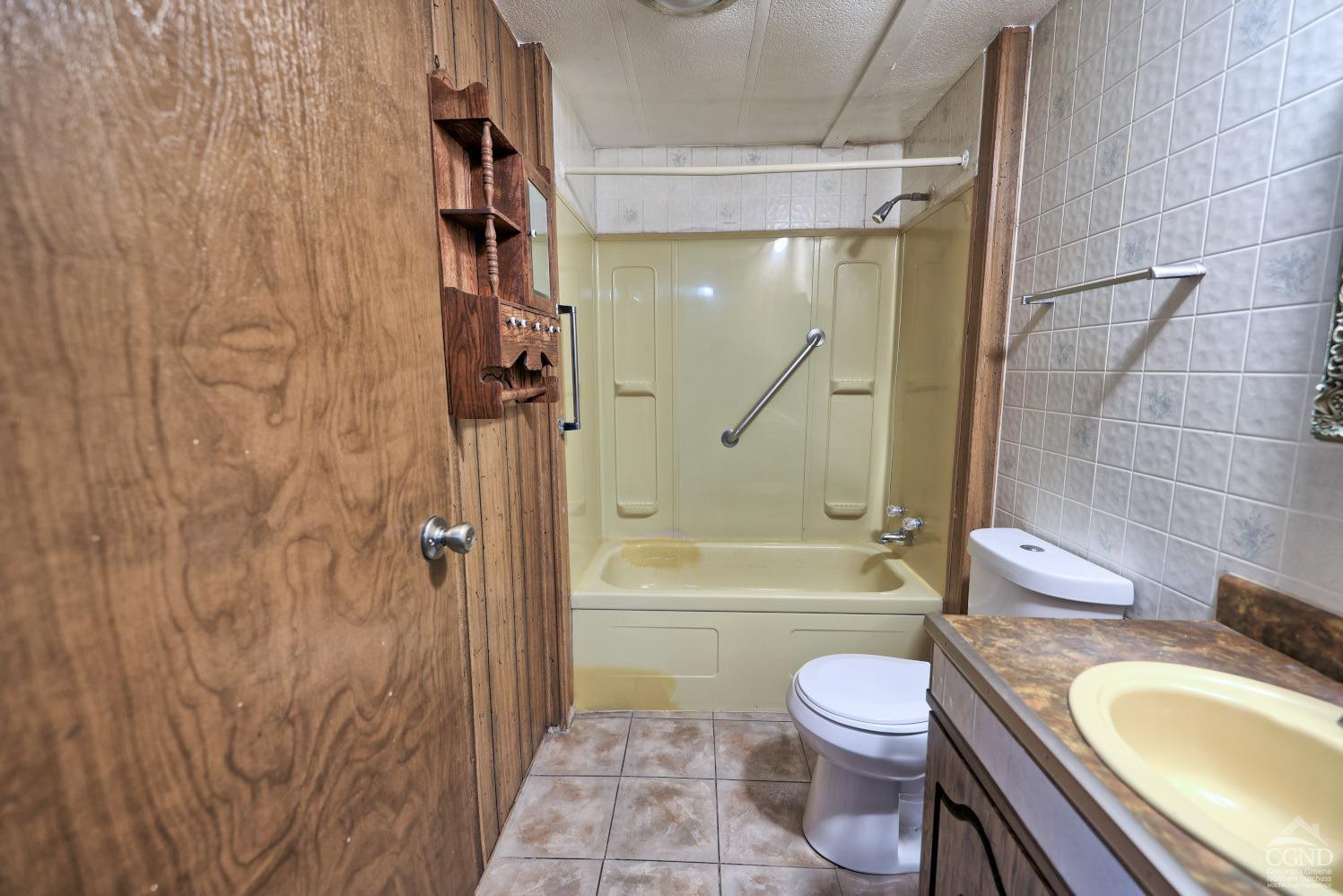 299 Main Street Cairo, NY 12413 - Photo 23 of 85 a bathroom with a granite countertop toilet a sink and bathtub