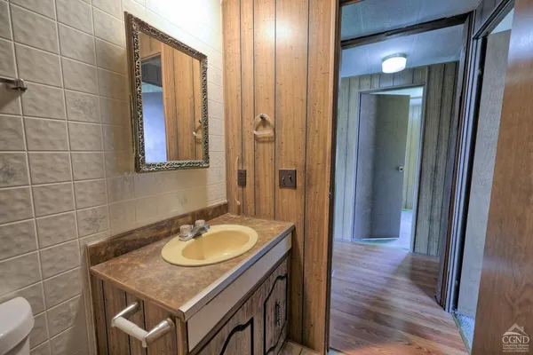 a bathroom with a double vanity sink and a mirror