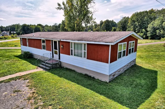 a view of a house with a backyard