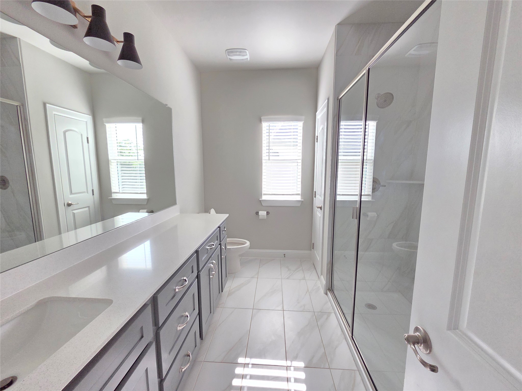 600 C-Bar Ranch Trail, Unit 121 Cedar Park, TX 78613 - Photo 25 of 32 A well-appointed primary bathroom showcases a lengthy vanity with dual sinks, offering both style and practicality.