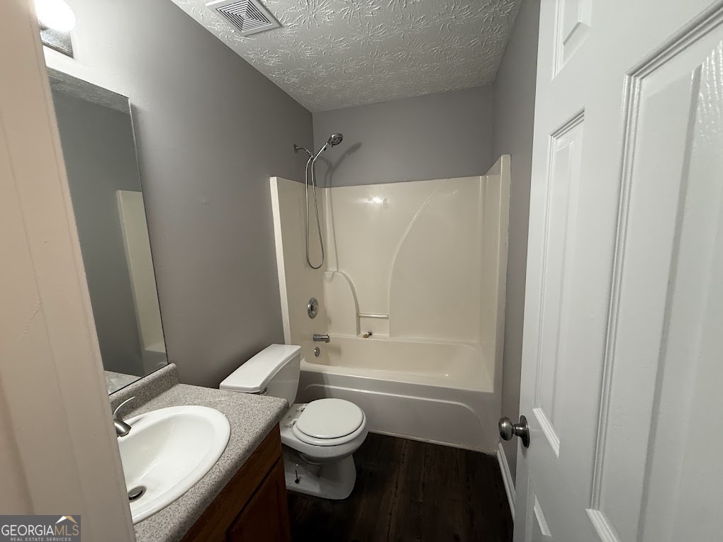 419 Shenandoah Court Winder, GA 30680 - Photo 12 of 12 a bathroom with a granite countertop bathtub shower sink vanity mirror and toilet