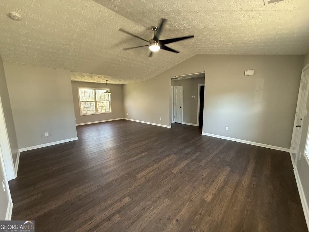 419 Shenandoah Court Winder, GA 30680 - Photo 5 of 12 an empty room with wooden floor fan and windows