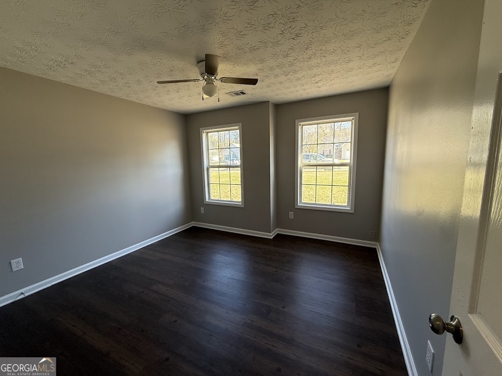 419 Shenandoah Court Winder, GA 30680 - Photo 9 of 12 a view of an empty room with wooden floor and a window