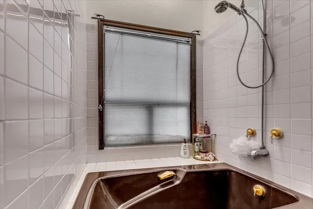 a bathroom with a granite countertop toilet sink and mirror