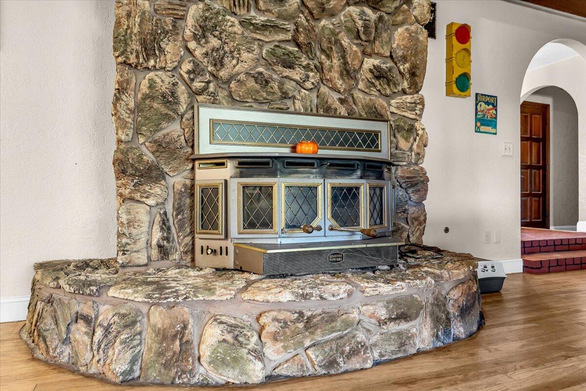 13160 Bear Mountain Road Redding, CA 96003 - Photo 25 of 40 a bed sitting in a bedroom next to a window with wooden floor