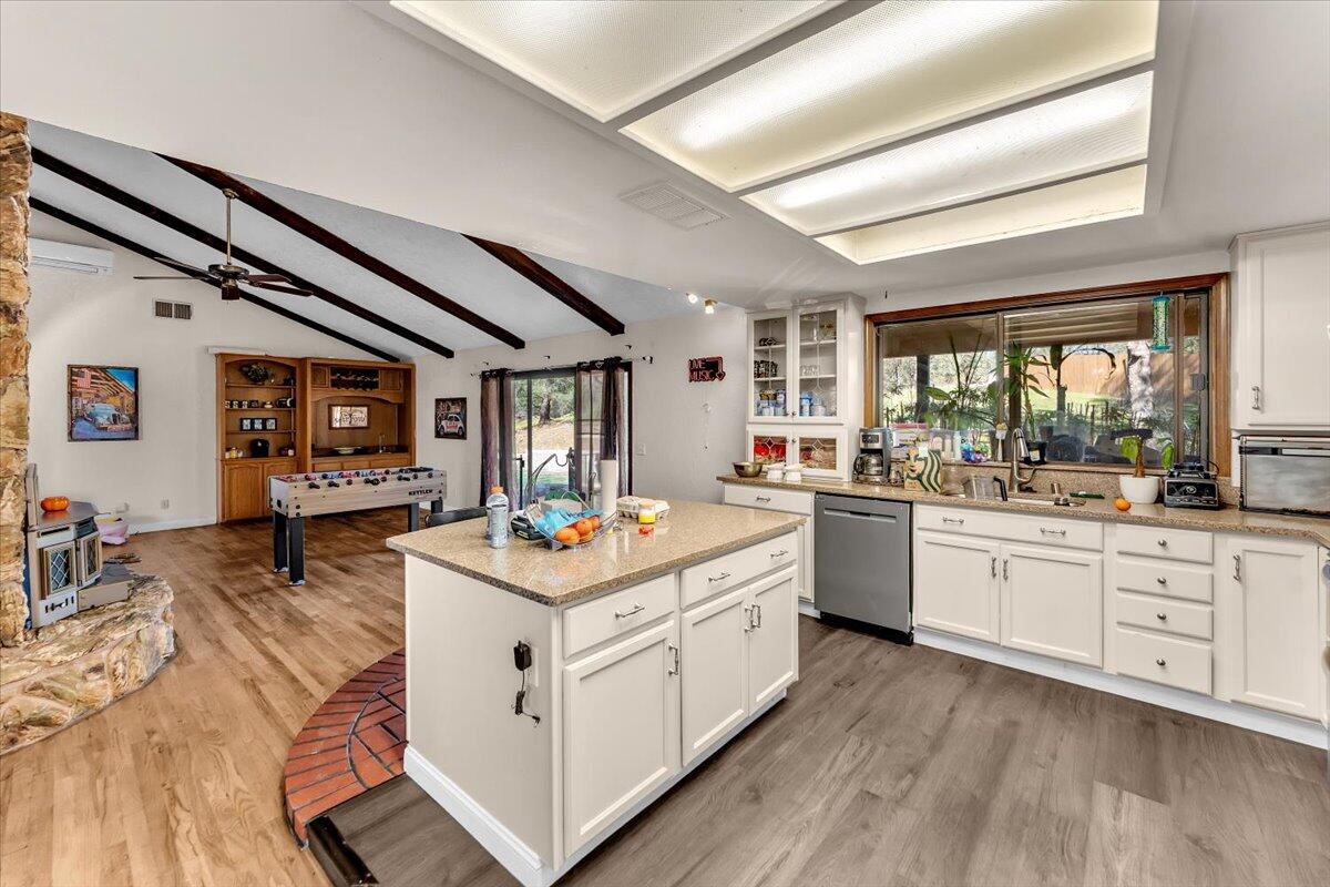 13160 Bear Mountain Road Redding, CA 96003 - Photo 26 of 40 a kitchen with sink stove and wooden floor