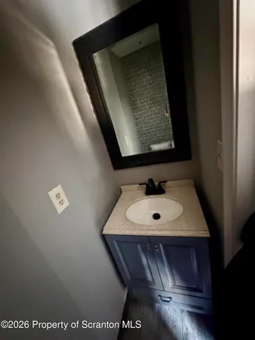 a view of an empty room with window and stairs