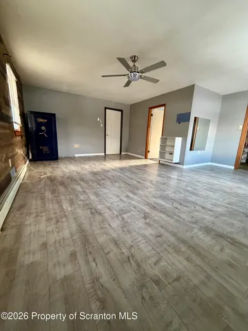 a view of a refrigerator in an empty room