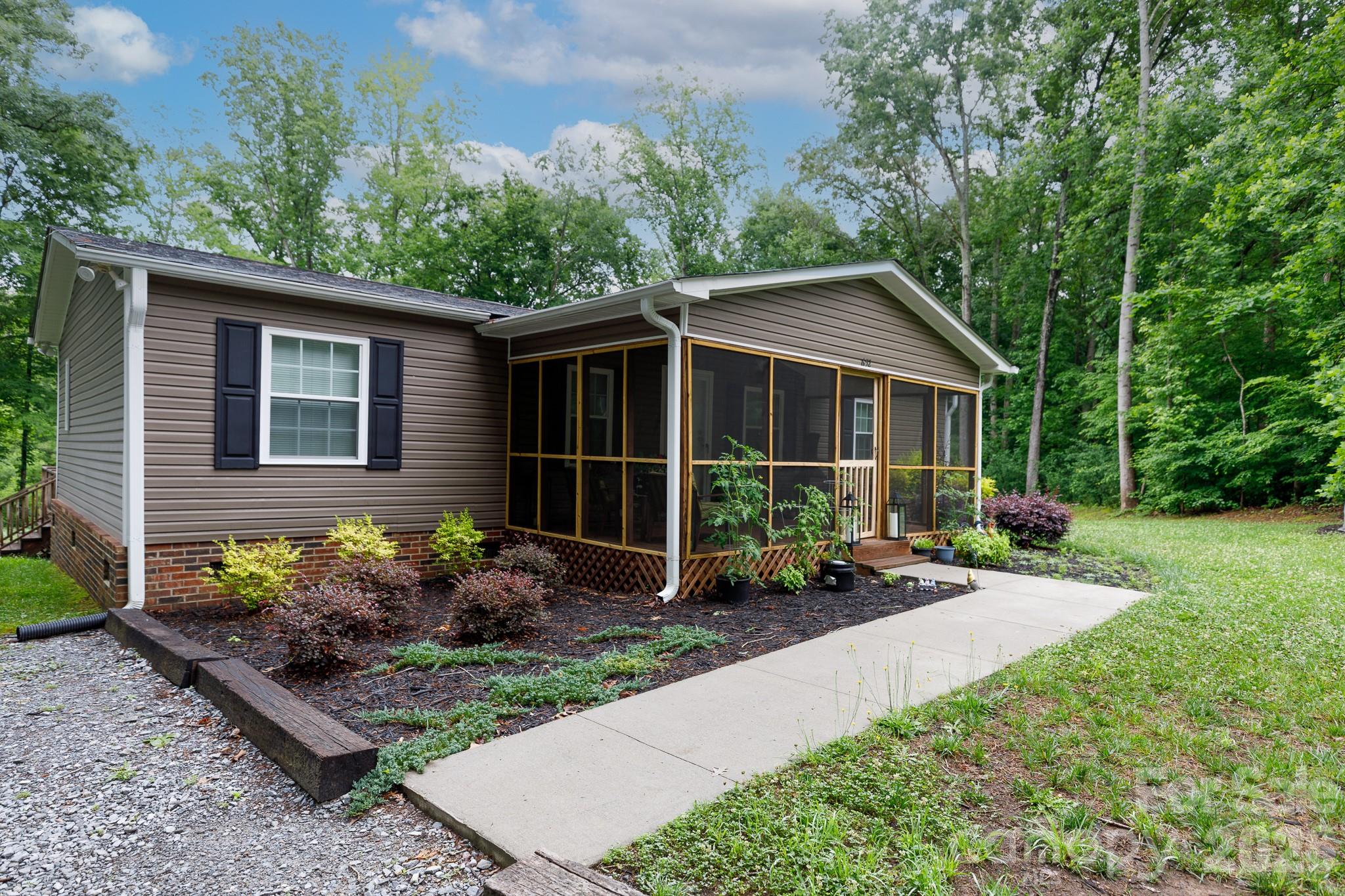 652 Sutton Spring Road York, SC 29745 - Photo 2 of 28 a front view of a house with garden