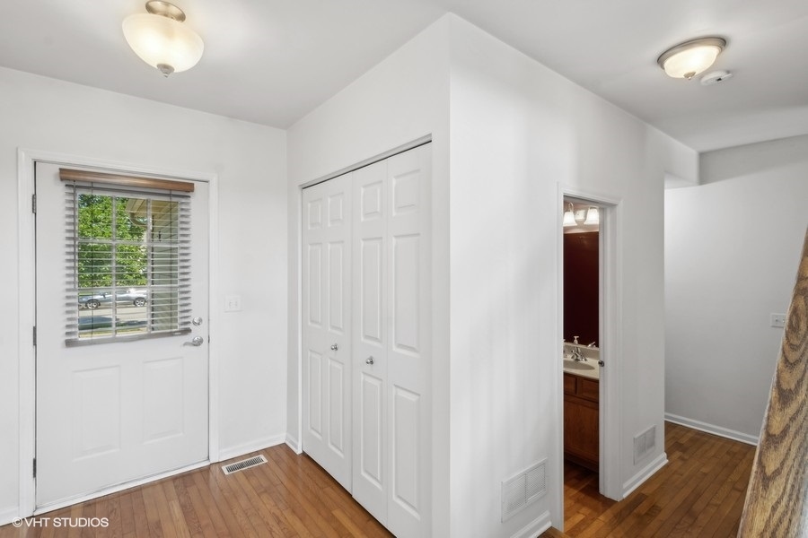 990 Oak Ridge Boulevard Elgin, IL 60120 - Photo 2 of 19 an empty room with wooden floor and windows