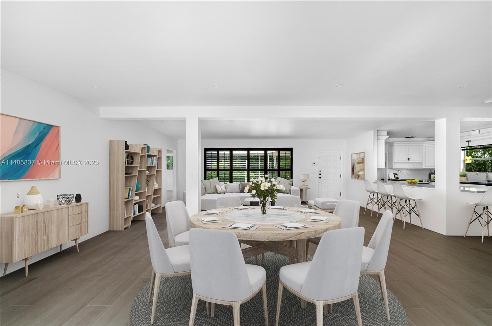 2385 North Bay Road Miami Beach, FL 33140 - Photo 11 of 35 a view of a dining room with furniture and wooden floor