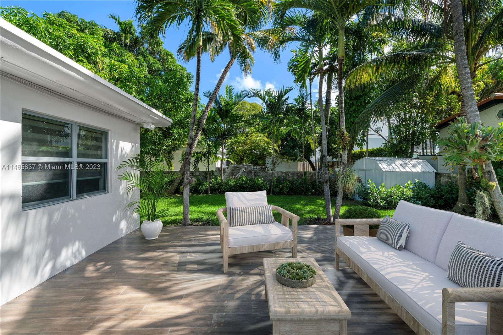 2385 North Bay Road Miami Beach, FL 33140 - Photo 30 of 35 a view of a patio with couches and a fire pit