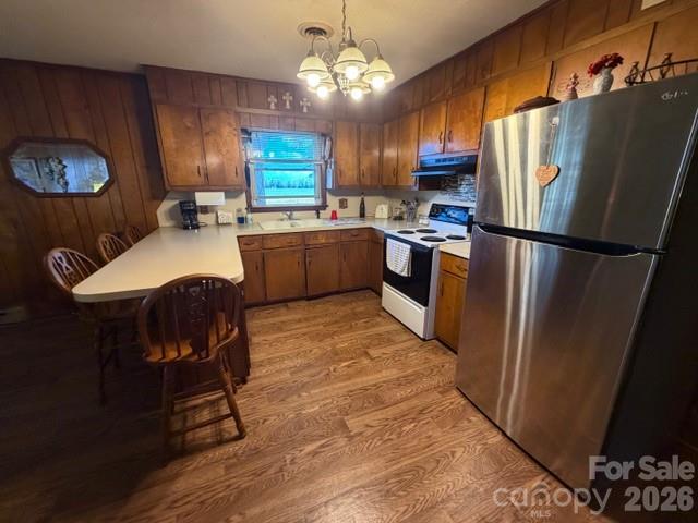 20415 Efird Road Albemarle, NC 28001 - Photo 7 of 16 a kitchen with stainless steel appliances granite countertop a refrigerator a stove a sink dishwasher a dining table and chairs with wooden floor