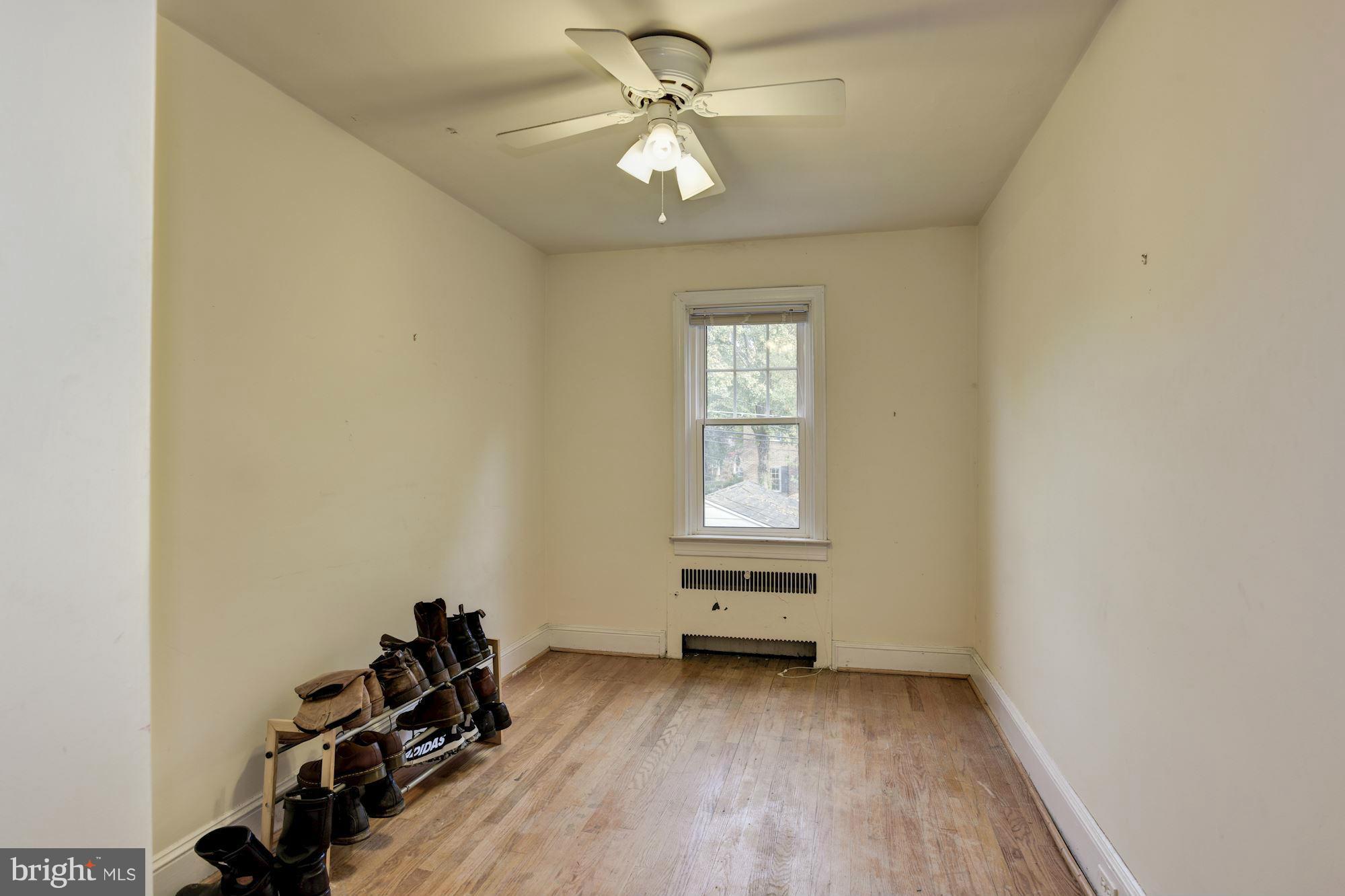 408 Hopkins Road Baltimore, MD 21212 - Photo 16 of 27 an empty room with windows and ceiling fan
