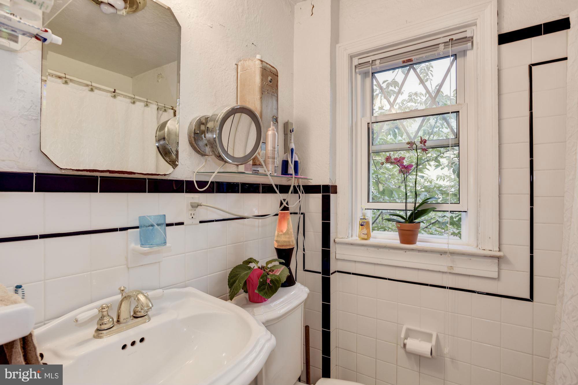 408 Hopkins Road Baltimore, MD 21212 - Photo 17 of 27 a bathroom with a sink and a mirror