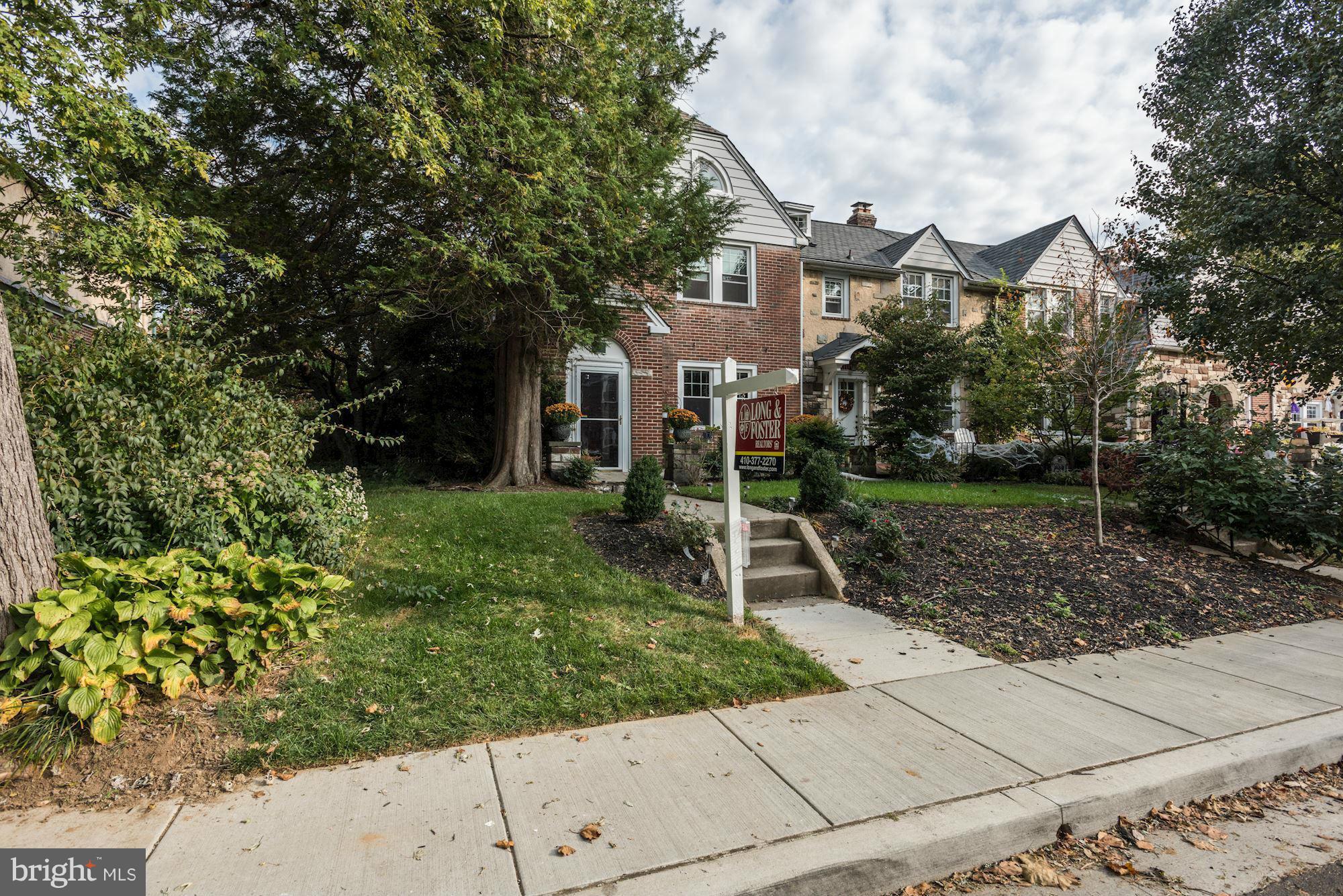 408 Hopkins Road Baltimore, MD 21212 - Photo 2 of 27 a front view of a house with a yard and potted plants