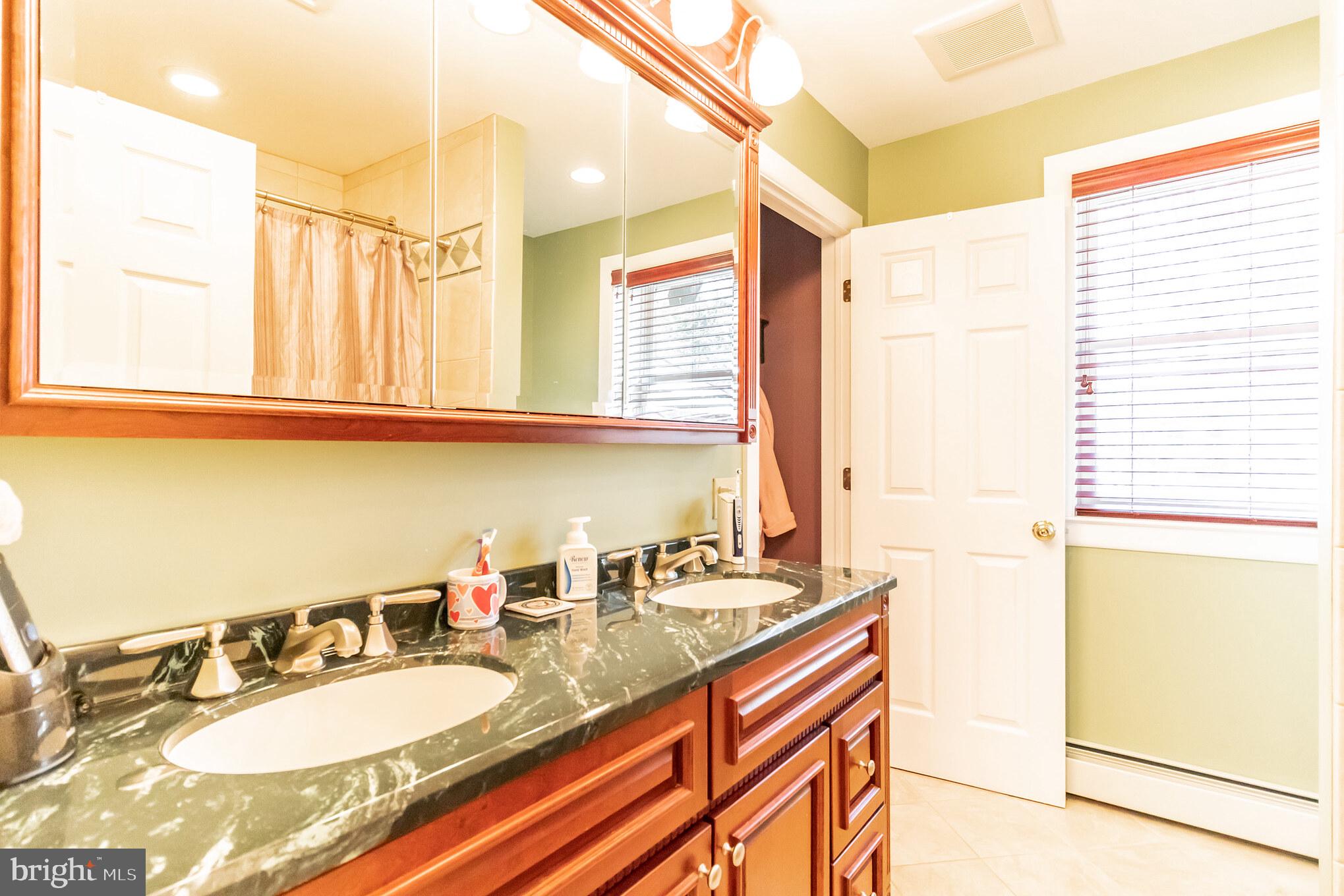 2441 Appleton Road Elkton, MD 21921 - Photo 19 of 32 a bathroom with a granite countertop sink and a mirror