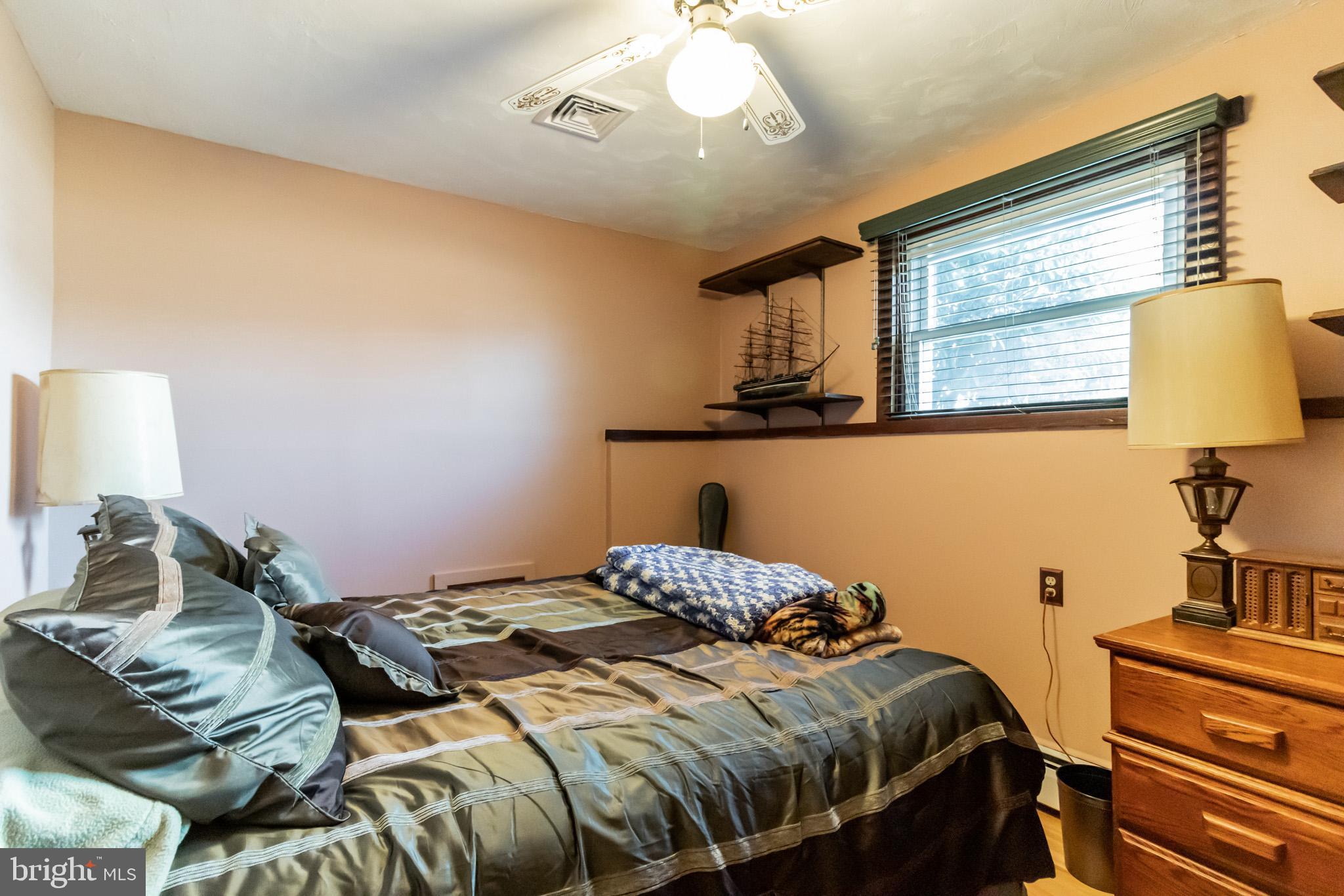 2441 Appleton Road Elkton, MD 21921 - Photo 23 of 32 a bedroom with a bed and a lamp with the dresser
