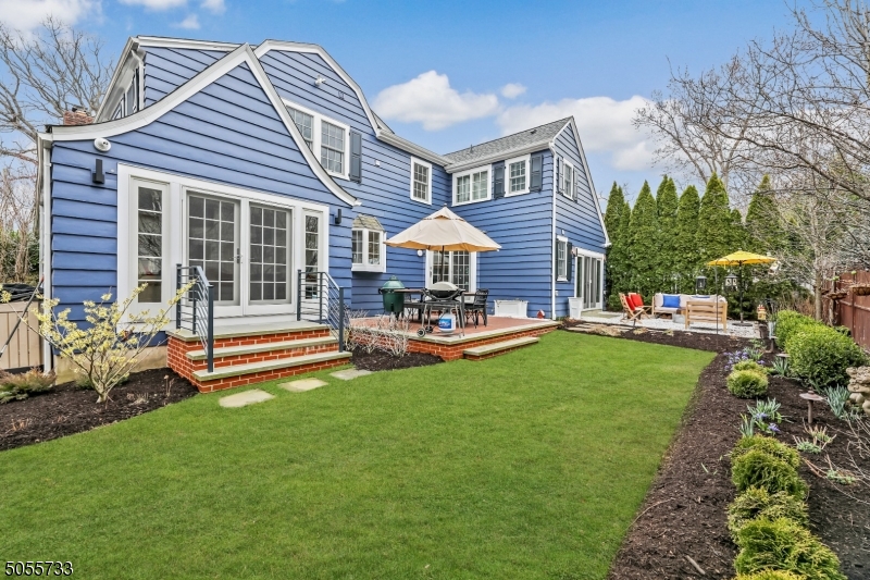 9 Hawthorne Road Short Hills, NJ 07078 - Photo 11 of 25 a front view of a house with a garden and patio