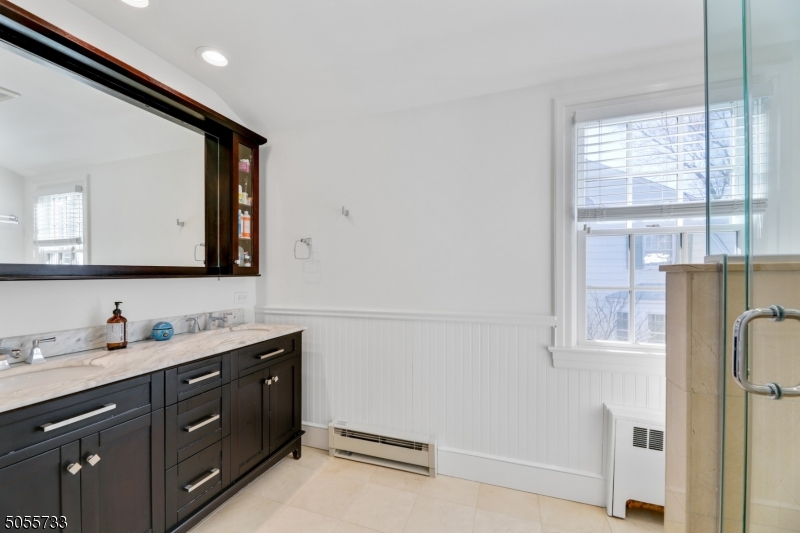 9 Hawthorne Road Short Hills, NJ 07078 - Photo 14 of 25 a bathroom with a double vanity sink and mirror