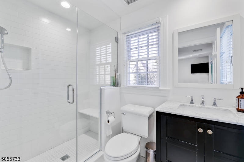 9 Hawthorne Road Short Hills, NJ 07078 - Photo 18 of 25 a bathroom with a sink toilet vanity and shower
