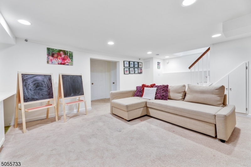 9 Hawthorne Road Short Hills, NJ 07078 - Photo 19 of 25 a living room with furniture and a flat screen tv
