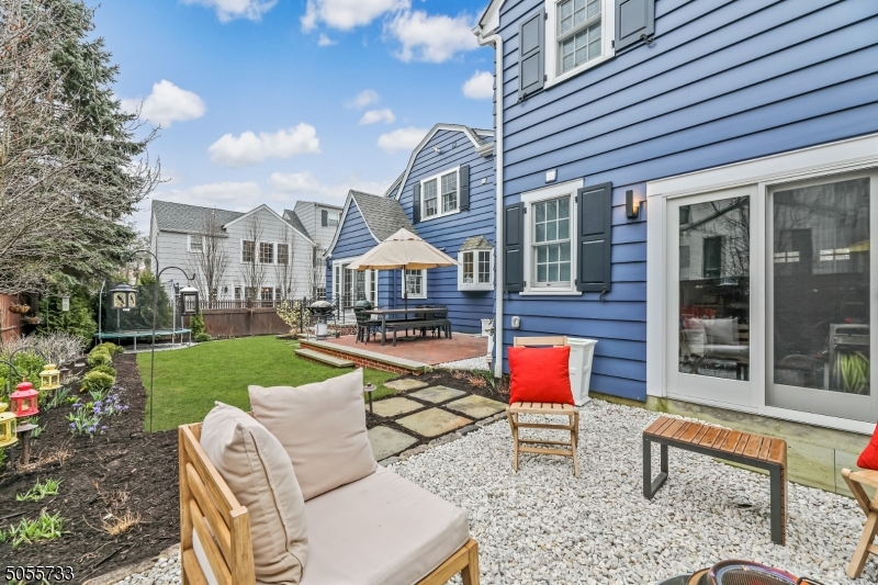 9 Hawthorne Road Short Hills, NJ 07078 - Photo 24 of 25 a front view of a house with garden and patio