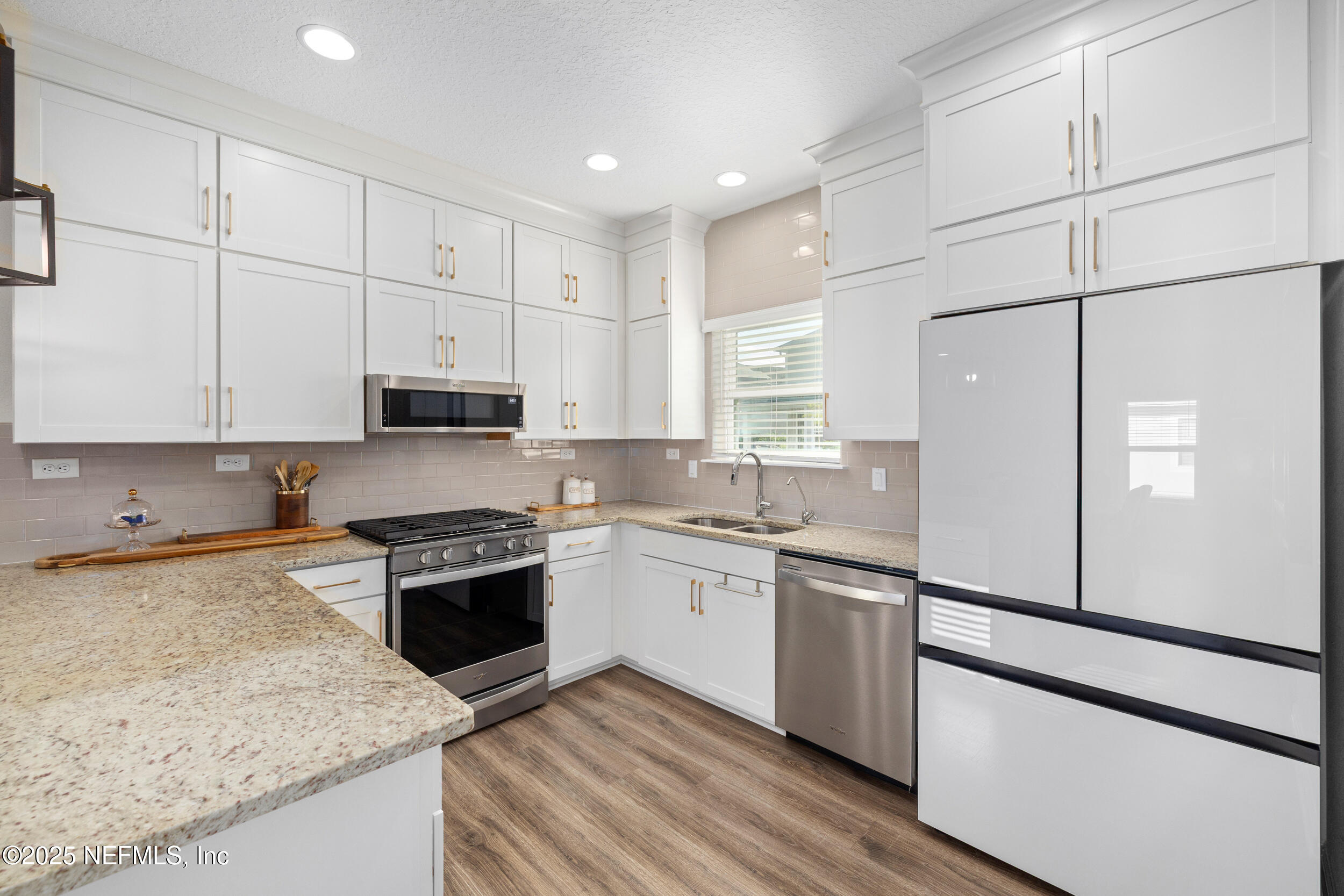 111 Beam Lane St. Augustine, FL 32095 - Photo 13 of 46 a kitchen with granite countertop white cabinets and white appliances