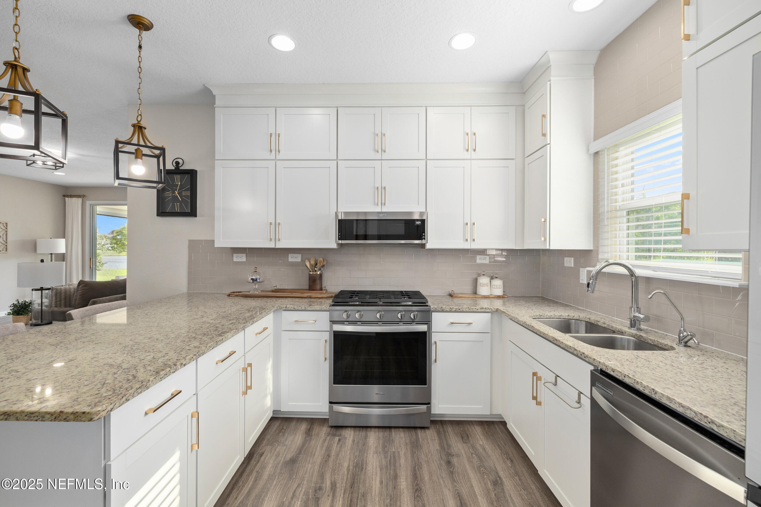 111 Beam Lane St. Augustine, FL 32095 - Photo 14 of 46 a kitchen with stainless steel appliances granite countertop a stove and white cabinets