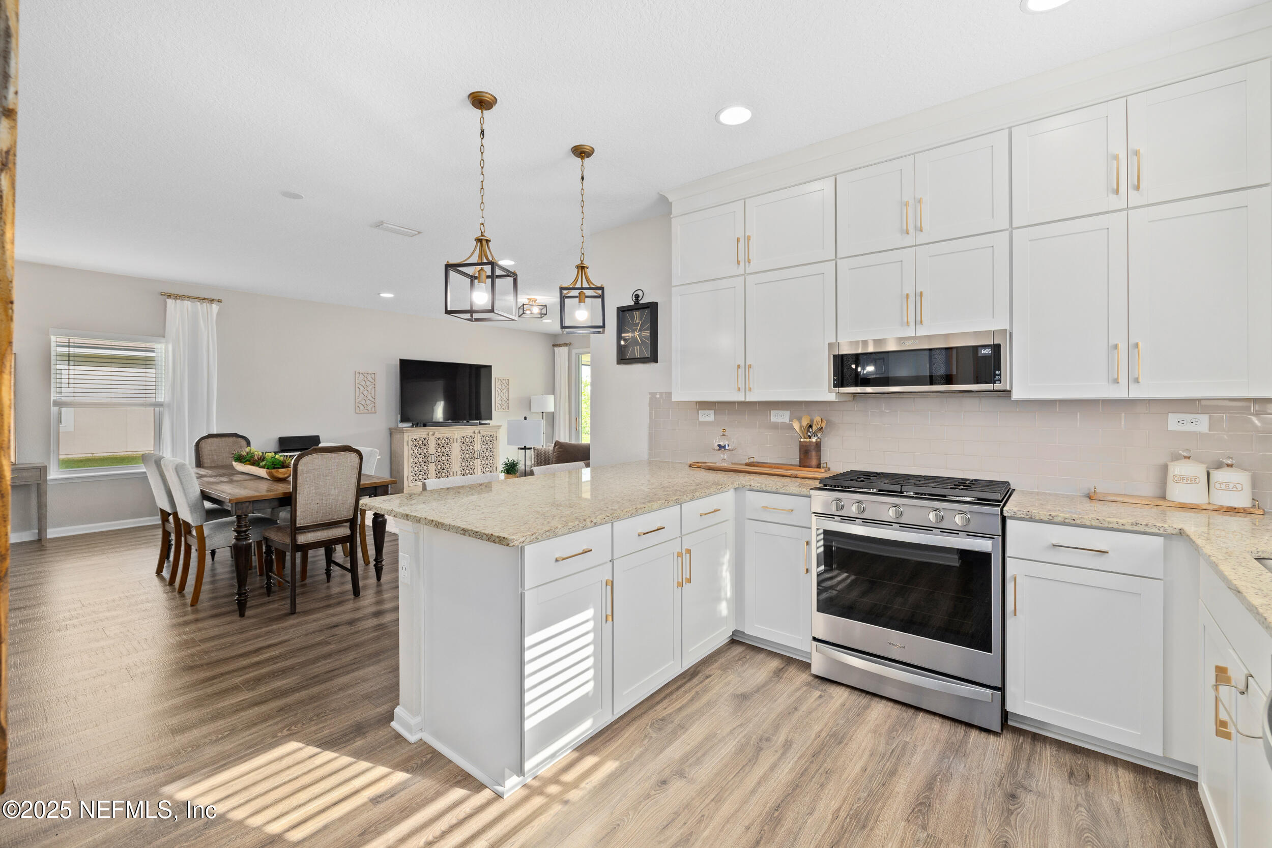 111 Beam Lane St. Augustine, FL 32095 - Photo 15 of 46 a open kitchen with stainless steel appliances granite countertop a stove top oven a sink dishwasher and a stove with white cabinets