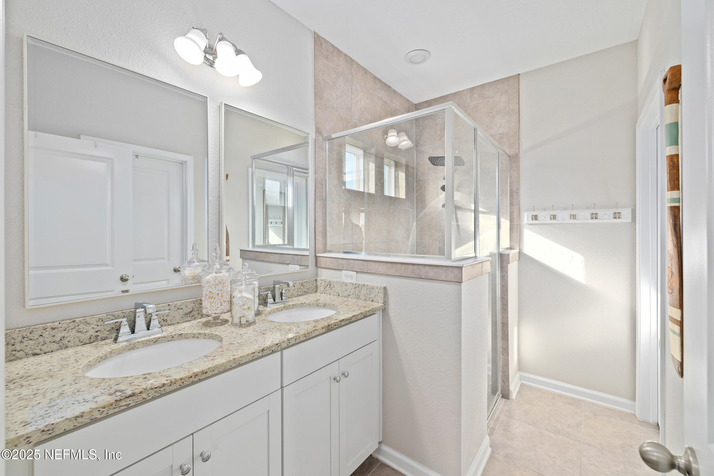 111 Beam Lane St. Augustine, FL 32095 - Photo 20 of 46 a bathroom with a granite countertop sink and a mirror