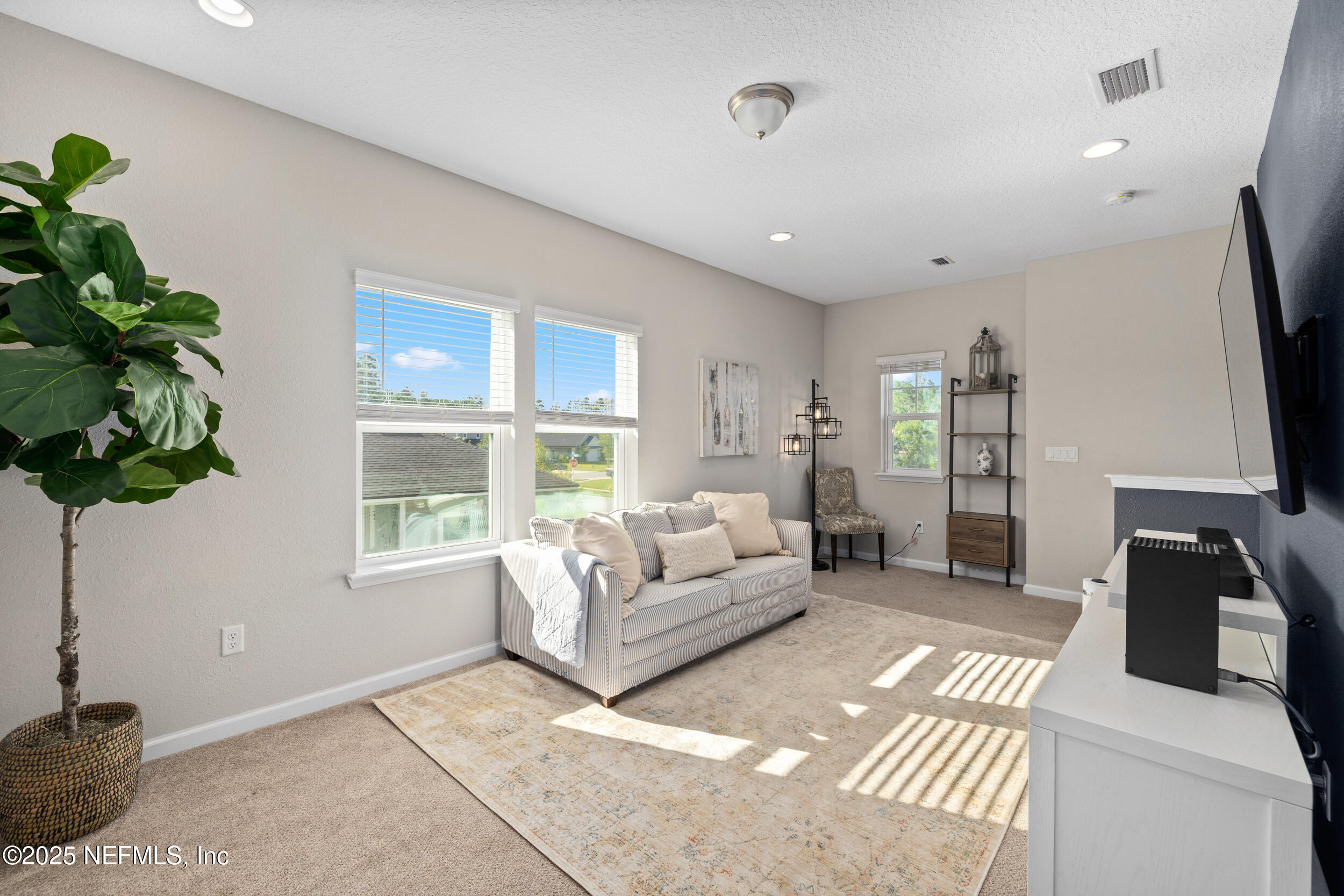 111 Beam Lane St. Augustine, FL 32095 - Photo 24 of 46 a living room with furniture a flat screen tv and a large window