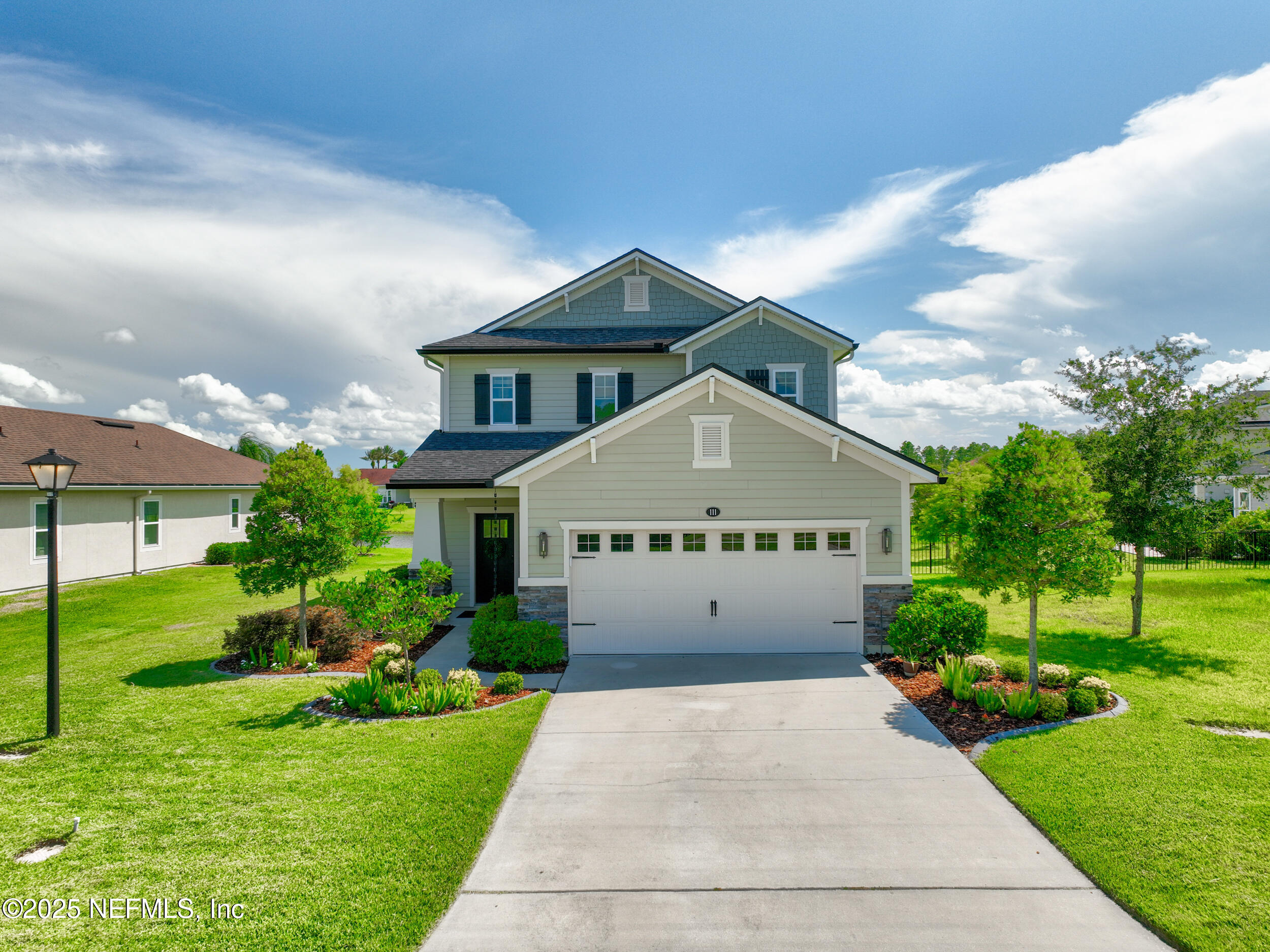 111 Beam Lane St. Augustine, FL 32095 - Photo 41 of 46 a front view of a house with a yard and garage