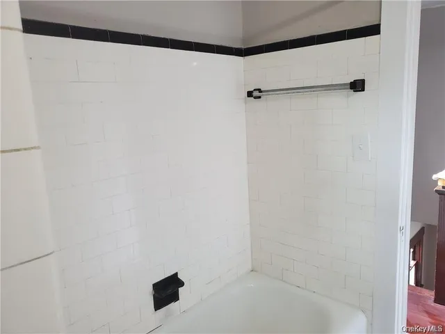 a bathroom with a shower and a bath tub