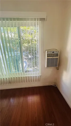 a view of a livingroom with wooden floor and a window