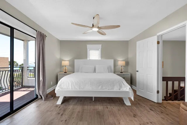 a bedroom with a bed and large window