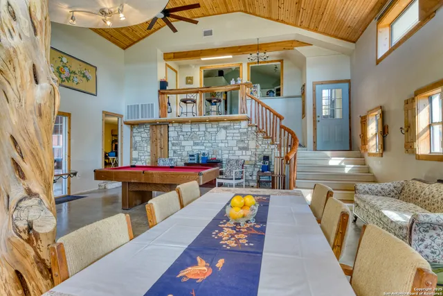 a dinning area with pool table and chairs