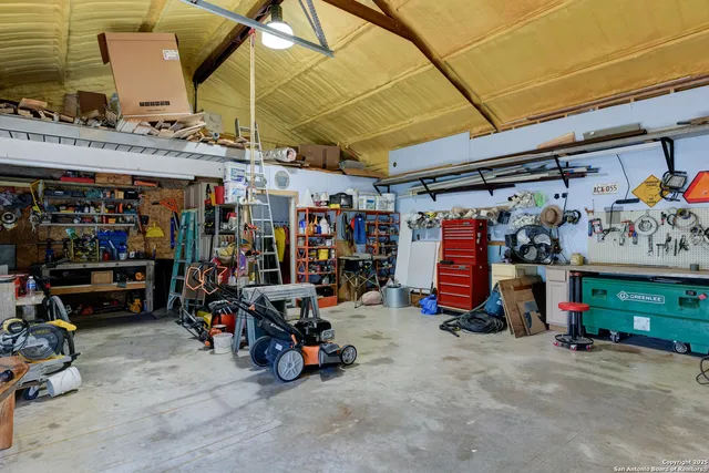 a view of a patio with table and chairs and potted plants with large tree