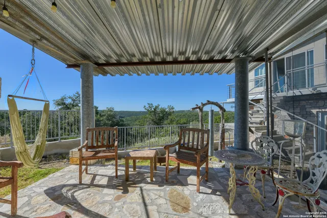 a view of a patio with couches chairs and table with wooden floor