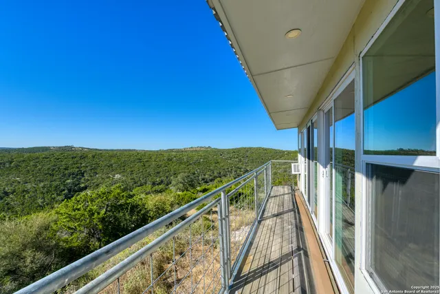 a view of a balcony with chairs