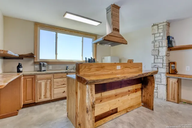 a living room with furniture a rug and a chandelier