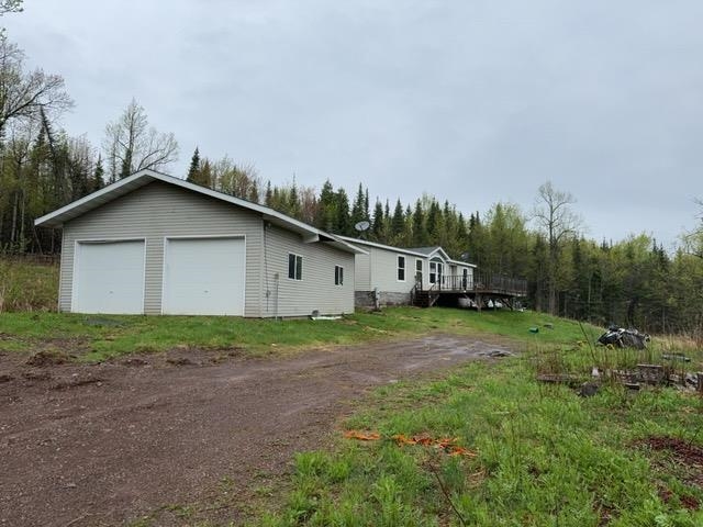 1335 Big Noise Pit Road Two Harbors, MN 55616 - Photo 1 of 20 View of side of property with a detached garage and a deck