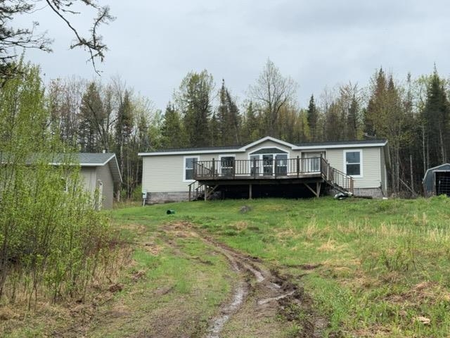 1335 Big Noise Pit Road Two Harbors, MN 55616 - Photo 14 of 20 Rear view of house featuring a deck, stairway, and an outdoor structure