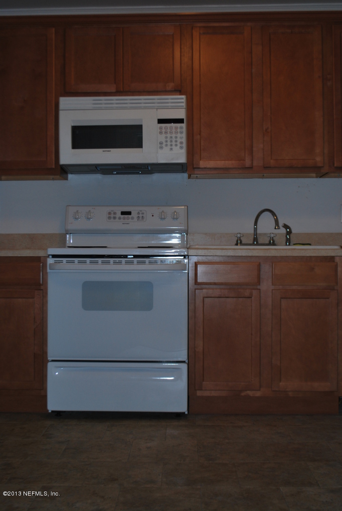 2915 Christopher Road Jacksonville, FL 32217 - Photo 6 of 26 a kitchen with granite countertop cabinets stainless steel appliances and a sink