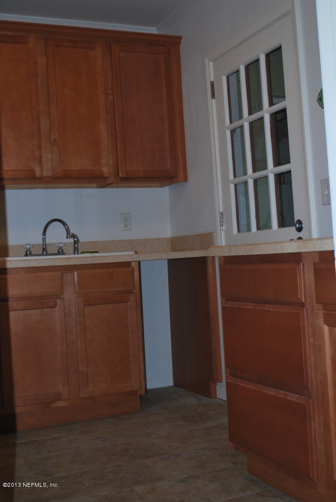 2915 Christopher Road Jacksonville, FL 32217 - Photo 8 of 26 a kitchen with a sink and cabinets