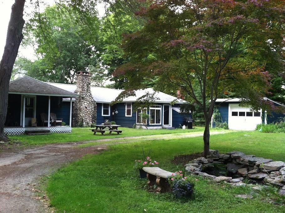 a front view of a house with a yard table and chairs