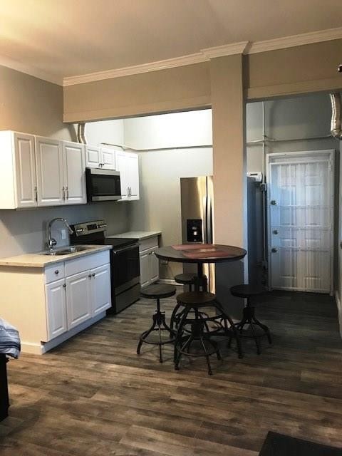 3522 Sampson Street Houston, TX 77004 - Photo 12 of 18 a kitchen with stainless steel appliances a microwave a sink and cabinets